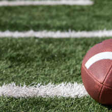close up of football laying on football field