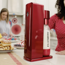 woman using red Ellemate drink maker