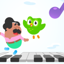 Duolingo with green bird flying over piano