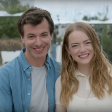 Nathan Fielder and Emma Stone standing next to each other and smiling at the camera in "The Curse."