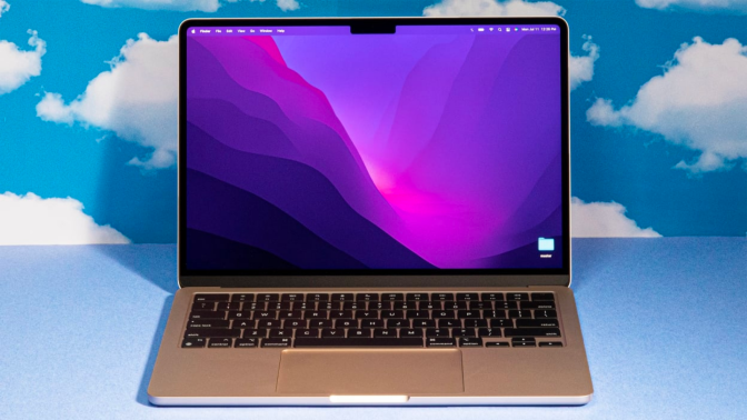 a 13-inch m2 apple macbook air against a cloud-patterned background