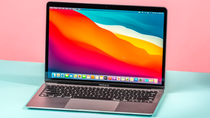 the m1 apple macbook air from late 2020 against a pink and aqua background