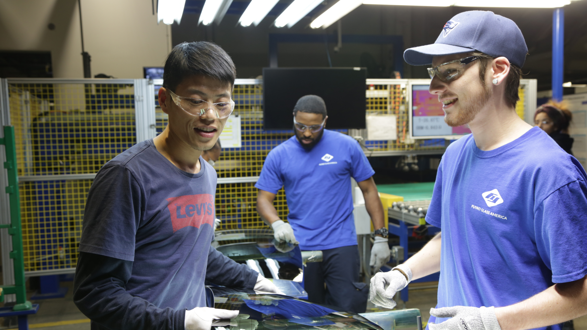 Wong He working with Kenny Taylor and Jarred Gibson in the Fuyao factory in Dayton, Ohio.