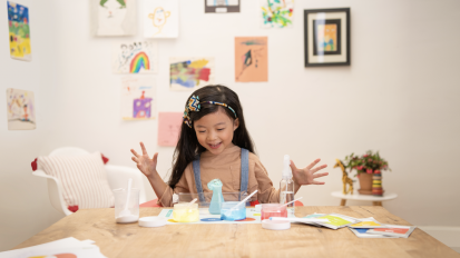 girl playing with science-themed activity box